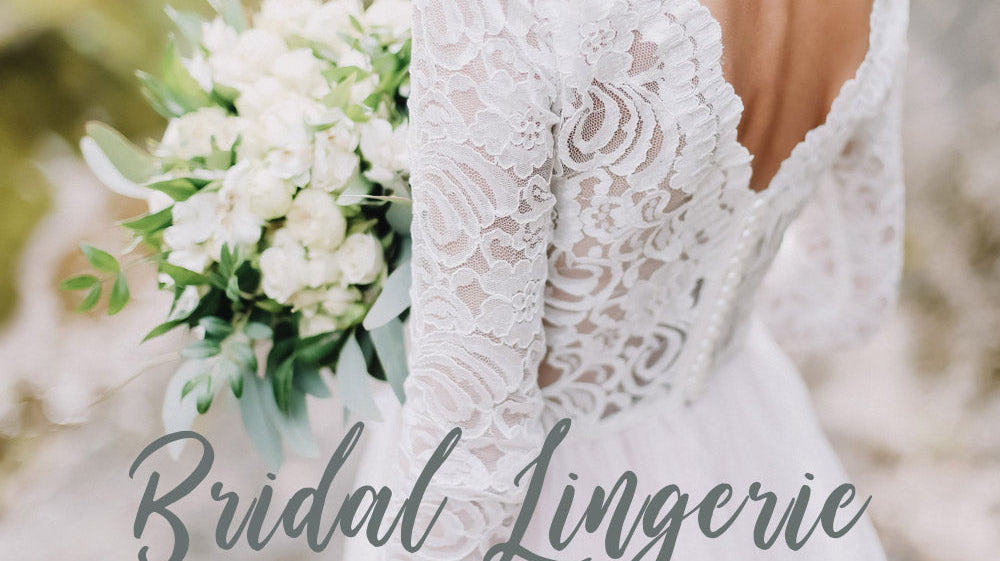 Bride holding a white bouquet, wearing a lace wedding dress with a low open back