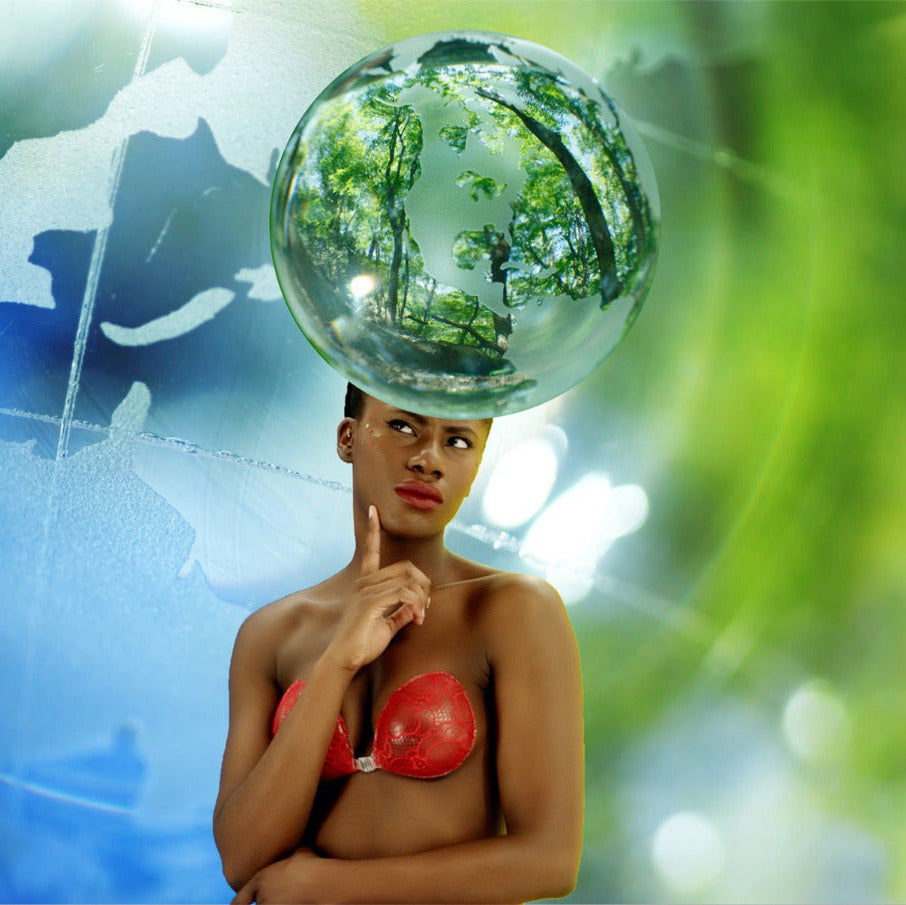 Woman holding a globe with trees on her head against a world map background
