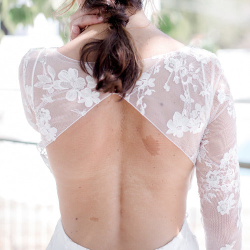 woman with braided hair and wedding dress with backless bra